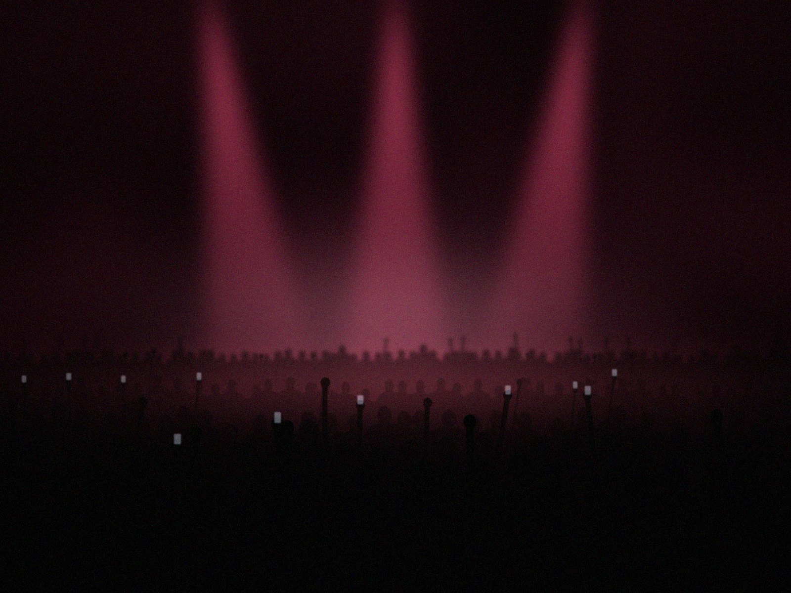 Pink spotlights over a packed room