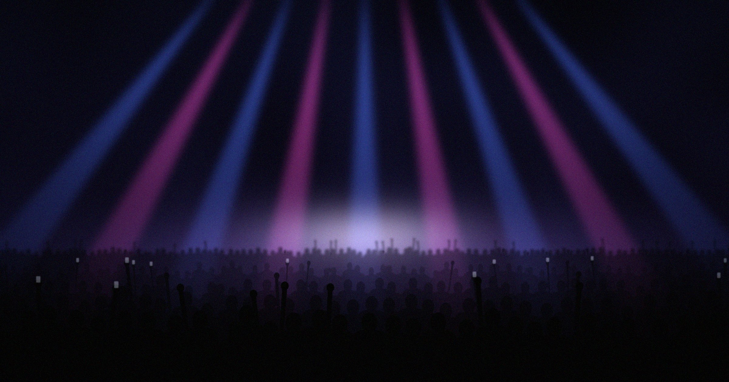 A crowd under blue and pink stage lights